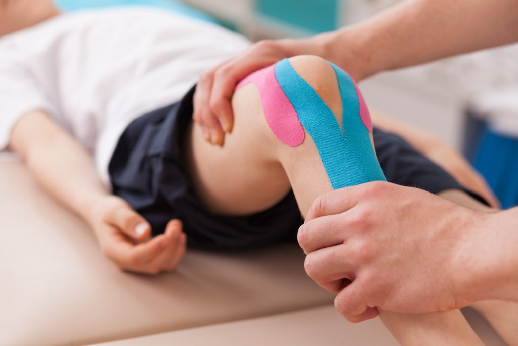 Physiotherapist,Doing,With,Child,Exercise,For,Knee